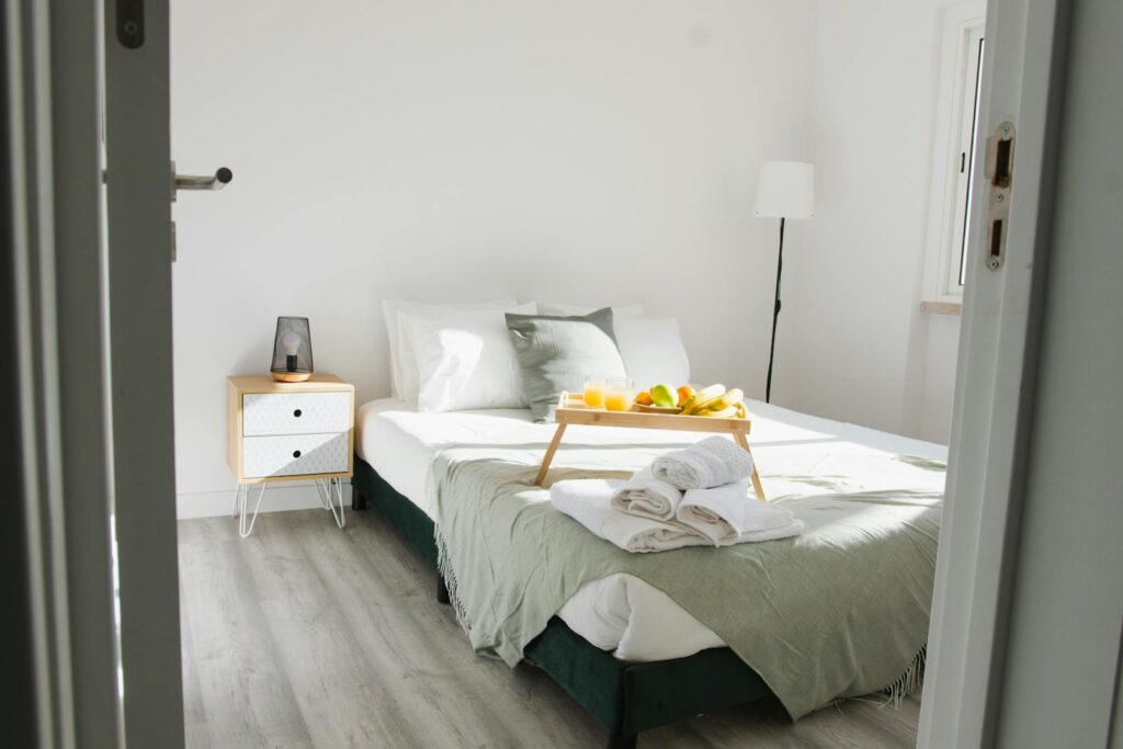 Airbnb bedroom styled with breakfast tray and fresh linens